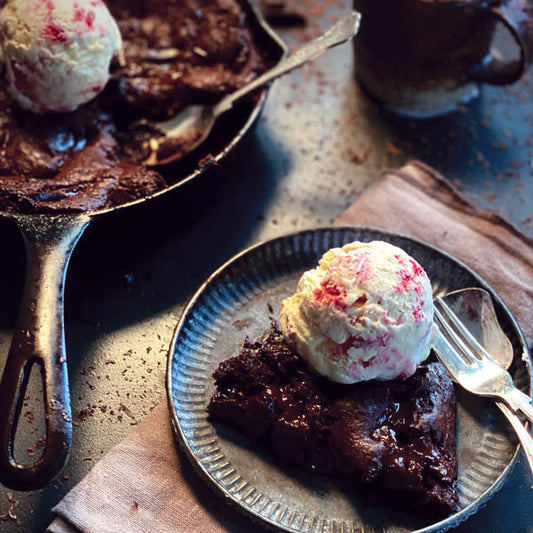 Gooey chocolate brownie served with ice cream on top